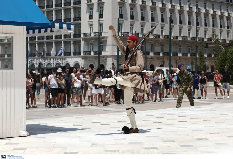 Τουρίστες παρακολουθούν την αλλαγή φρουράς στο Μνημείο του Άγνωστου Στρατιώτη Τουρίστες παρακολουθούν την αλλαγή φρουράς στο Μνημείο του Άγνωστου Στρατιώτη