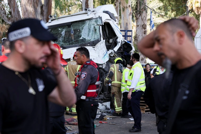 Israeli emergency services work at the scene where a truck rammed into pedestrians at a bus stop, in Ramat Hasharon, Violeta Santos Moura/Reuters