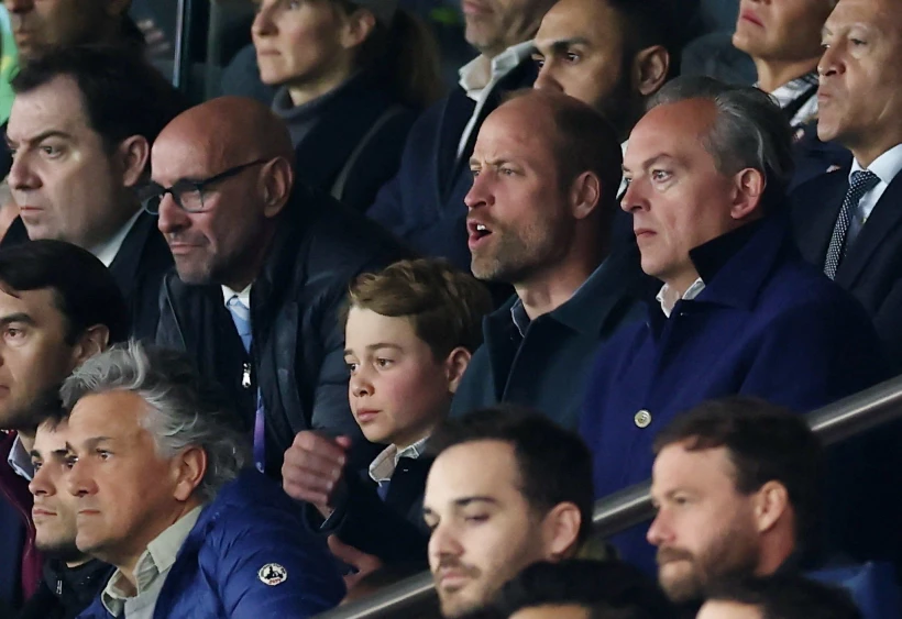           Prince William and his son Prince George in the stands - REUTERS     