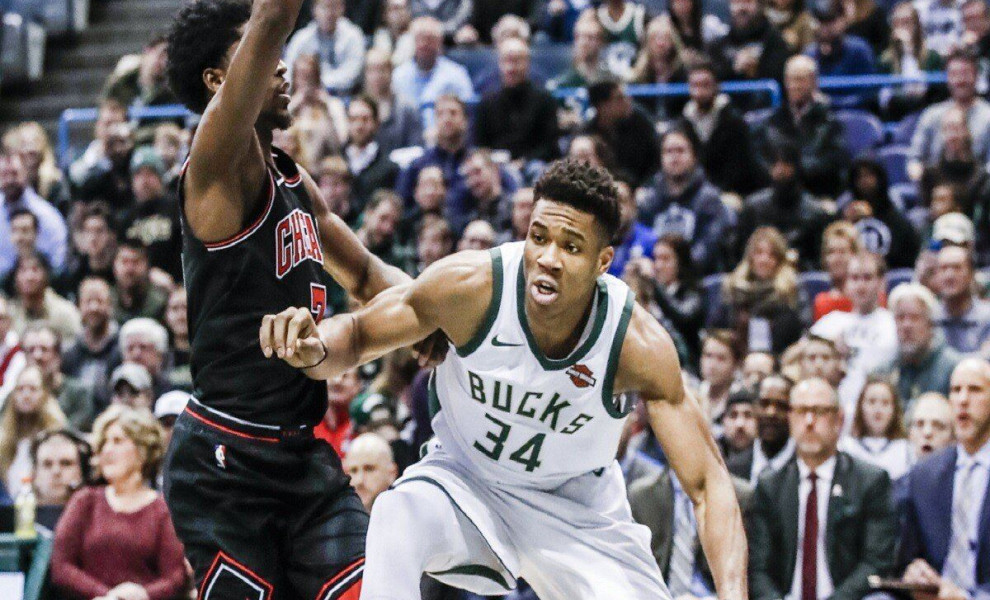 epa06406432 Milwaukee Bucks forward Giannis Antetokounmpo of Greece (R) steps out of bounds while being guarded by Chicago Bulls guard Justin Holiday (L) in the first half of their NBA game at the BMO Harris Bradley Center in Milwaukee, Wisconsin, USA, 26
