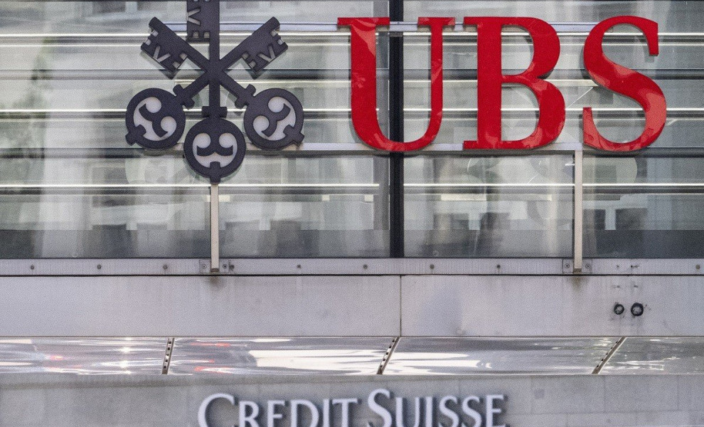 epa10686607 The two logos of the banks UBS and Credit Suisse in Zurich, Switzerland, 12 June 2023. "UBS has completed the legal closing of its acquisition of Credit Suisse" Swiss bank UBS, now Switzerland's only major bank, announced in an open letter pub