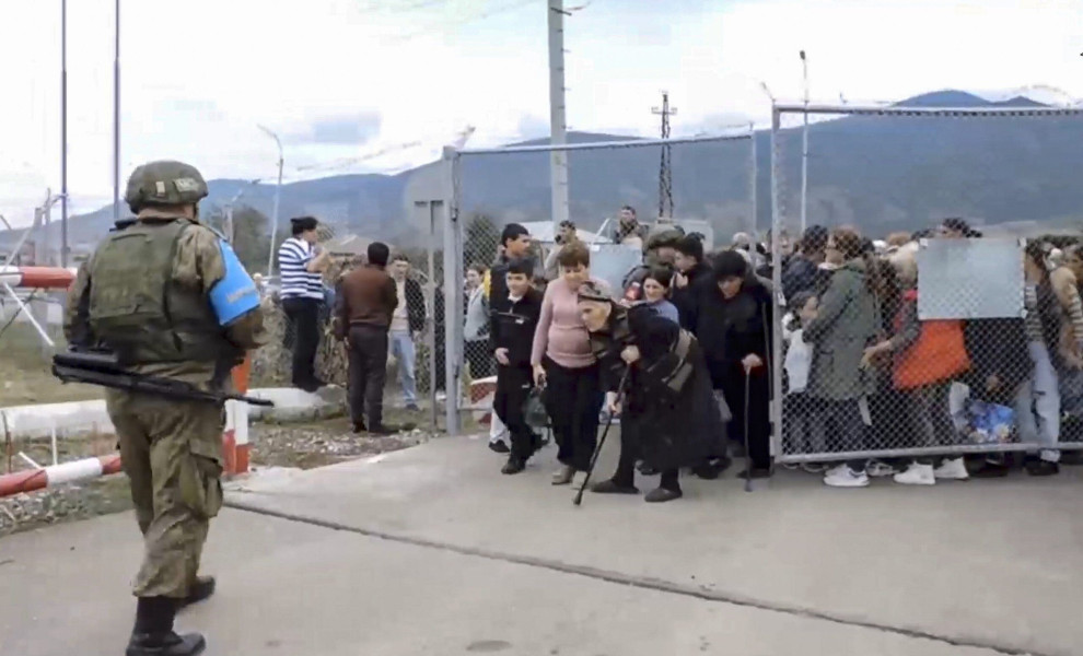 epa10873895 A still image taken from a handout video provided by the Russian Defence Ministry press-service shows civilians entering a Russian peacekeepers' camp near Stepanakert, Nagorno-Karabakh, 21 September 2023. About 5,000 people have been brought t