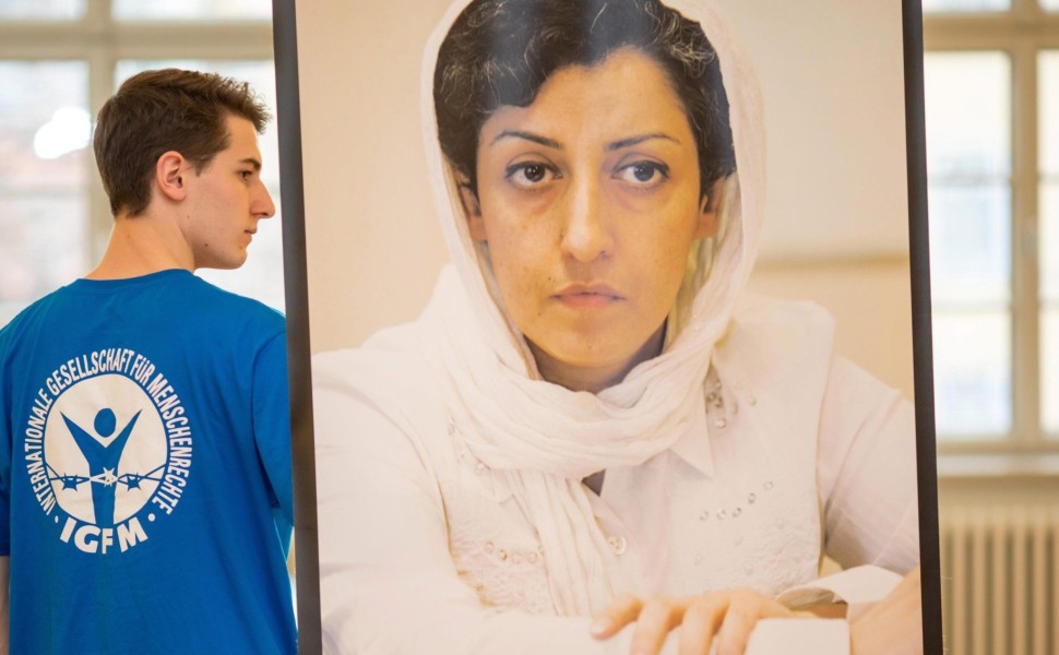 epa05669066 A man carrying a picture of award winner Narges Mohammadi from Iran at a press conference for the Weimar Human Rights Award in Weimar, Germany, 10 December 2016. Narges Mohammadi was vice president of the now banned Iranian human rights organi epa05669066 A man carrying a picture of award winner Narges Mohammadi from Iran at a press conference for the Weimar Human Rights Award in Weimar, Germany, 10 December 2016. Narges Mohammadi was vice president of the now banned Iranian human rights organi
