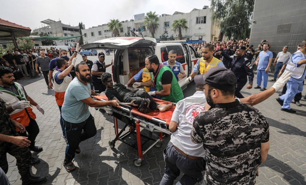 epa10909024 Palestinians rush a wounded youth to an ambulance after an Israeli air strike in Gaza City, 09 October 2023. The Israeli army announced on 09 October, it carried out over 500 strikes on targets across the Gaza Strip overnight. Palestinian offi