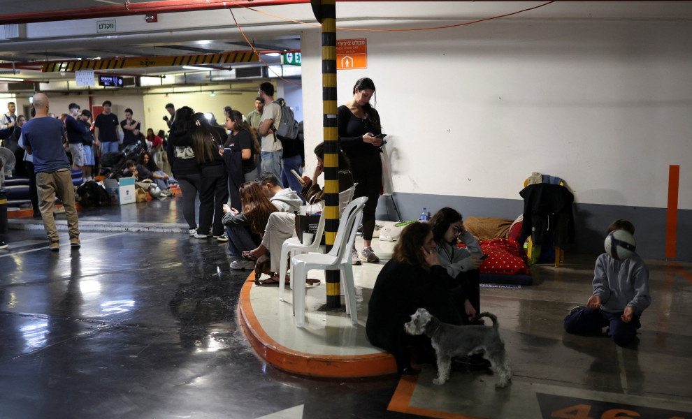 Israelis shelter in an underground parking garage, REUTERS/Ronen Zvulun