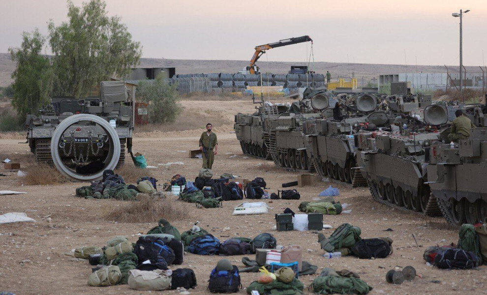 epaselect epa10909663 Israeli reservists prepare next to armored personnel carriers (APCs) at a military camp near Beer Sheva, Israel, 09 October 2023. Israeli chief military spokesperson Rear-Admiral Daniel Hagari said on 09 October that the country had 